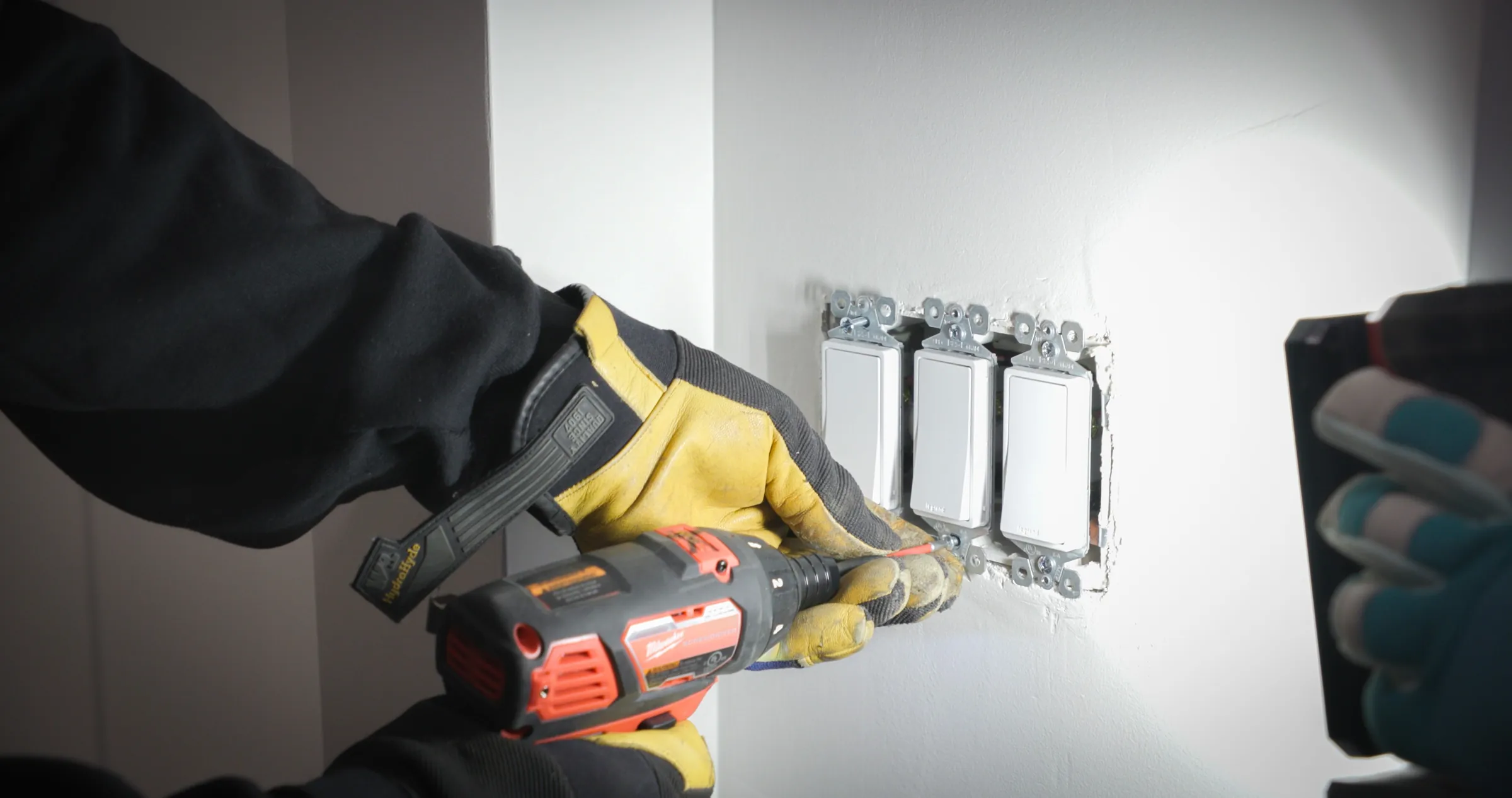 An Unlimited Electric electrician at work in a customer’s home